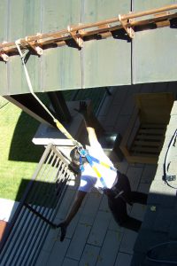 hanging from safety harness from copper snow guards