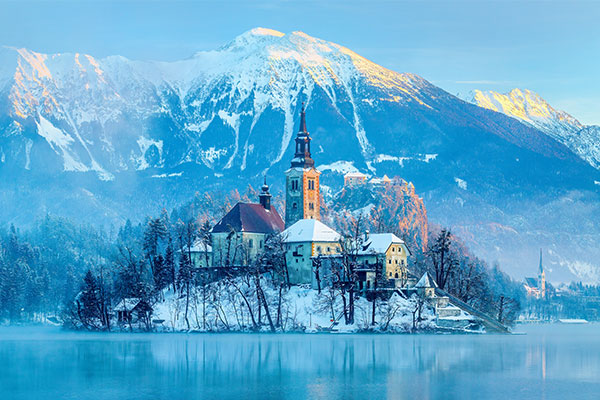 Alps landscape with home and church on lake