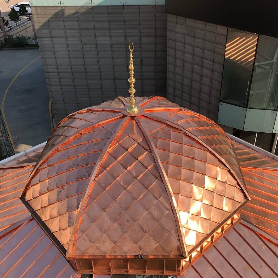 Copper dragon scale shingles on dome roof in city