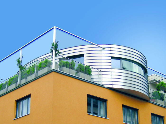 stainless steel radius cladding on a rounded portion of a modern building