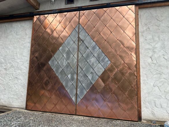Sliding barn doors clad with copper and stainless diamond shaped panels